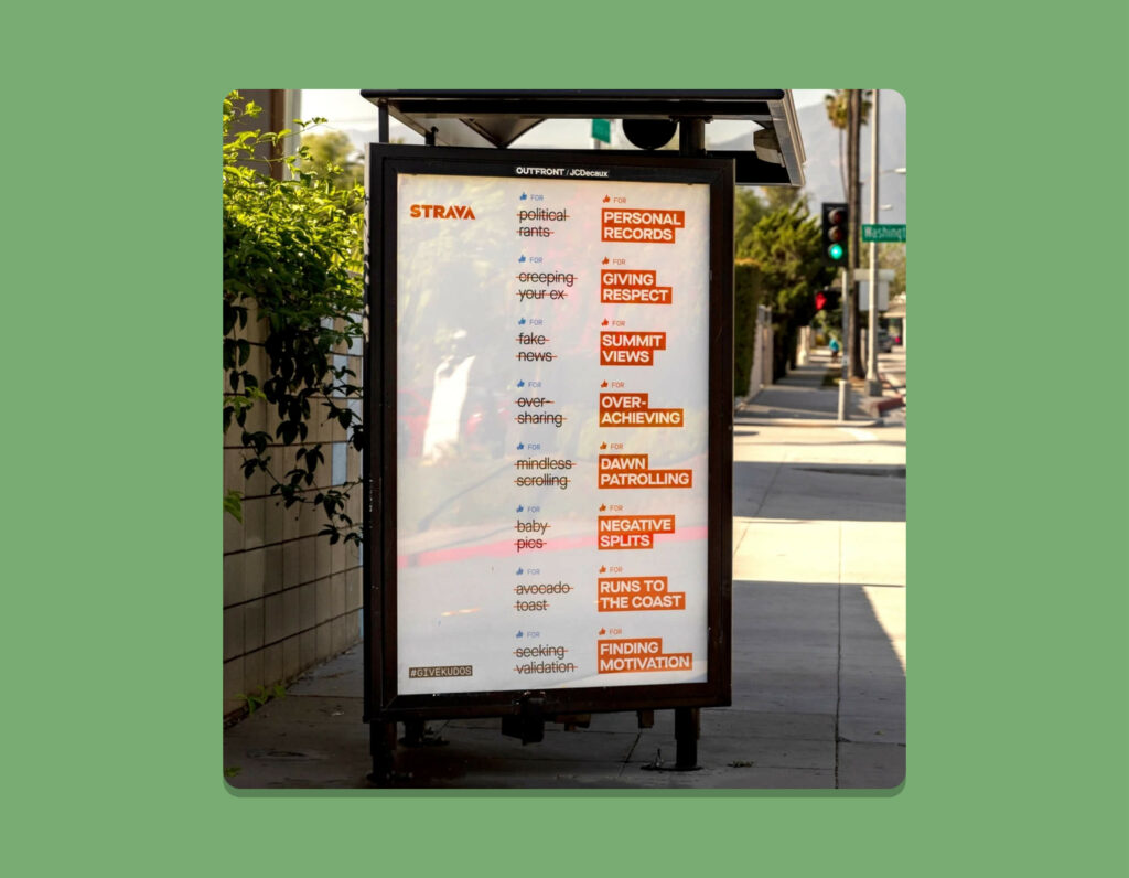A bus stop advertisement from Strava's #GiveKudos Initiative