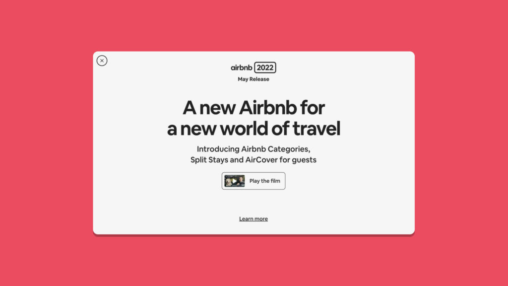 A pop up that comes up when entering the Airbnb desktop product, stating - "A new Airbnb for a new world of travel" - giving you an option to play the film, learn more or exit out.